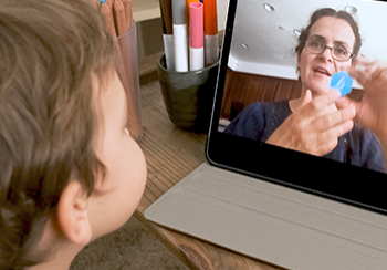 Child learning being taught remotely on a laptop